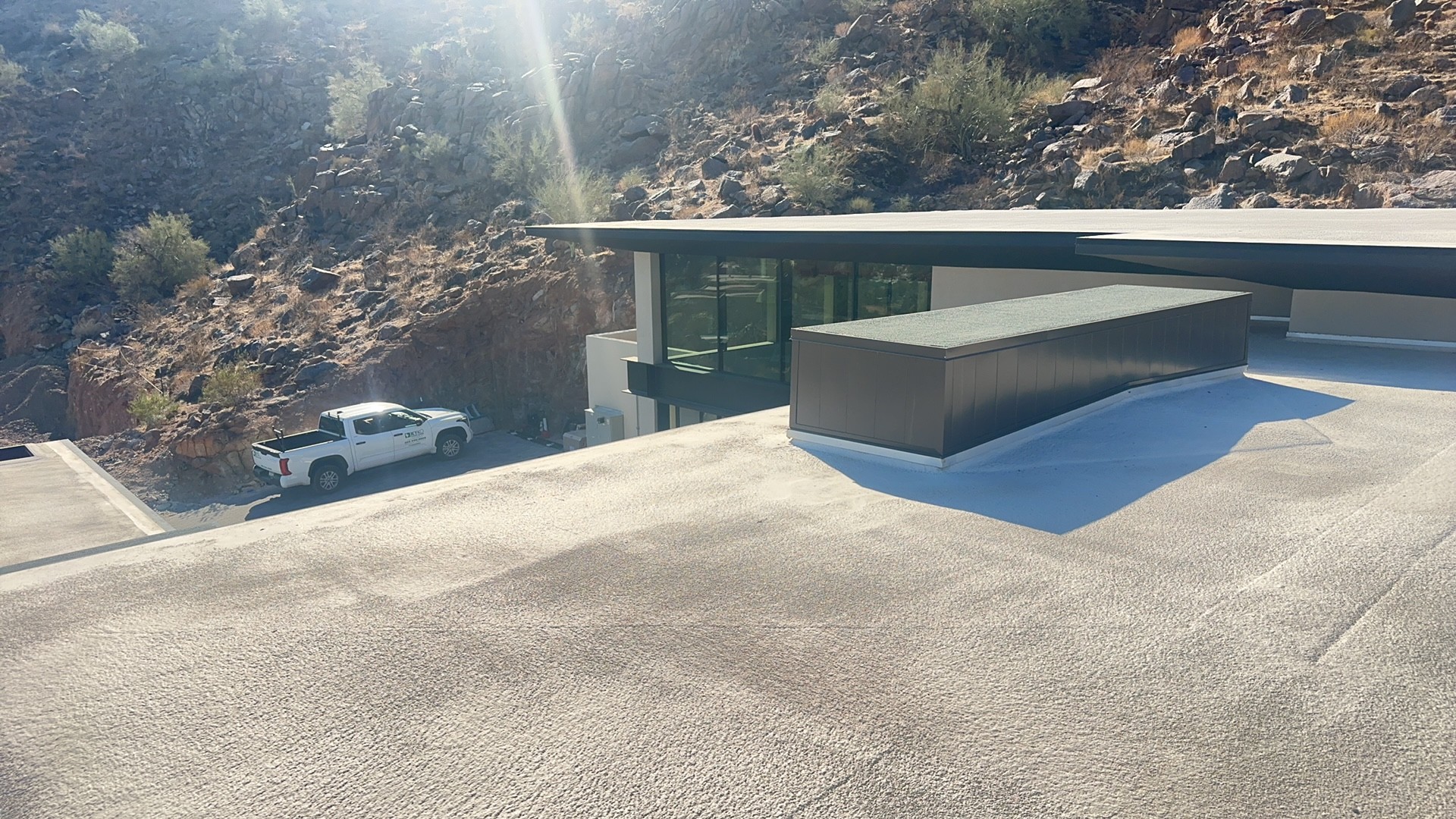 Low-slope flat roof · Camelback East Village, Scottsdale 85251 — Modern hillside home with a large low-slope deck needed a durable, walkable surface that could handle the desert sun and reflect heat off the living space below.