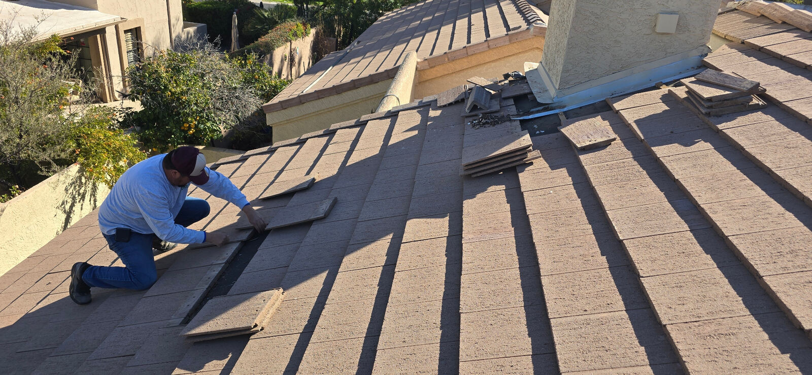 Concrete tile · Scottsdale · October 2025 — Aging underlayment and failed flashing details around a chimney causing recurring leaks.