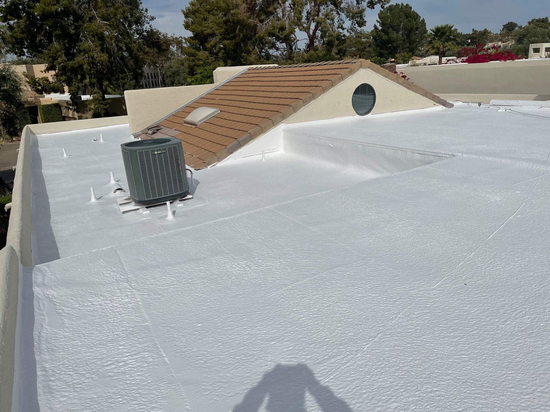 Full flat-roof recoat · Phoenix Valley — Aging coating worn thin around the AC curb and roof penetrations — owner wanted a full recoat before leaks started showing up inside.