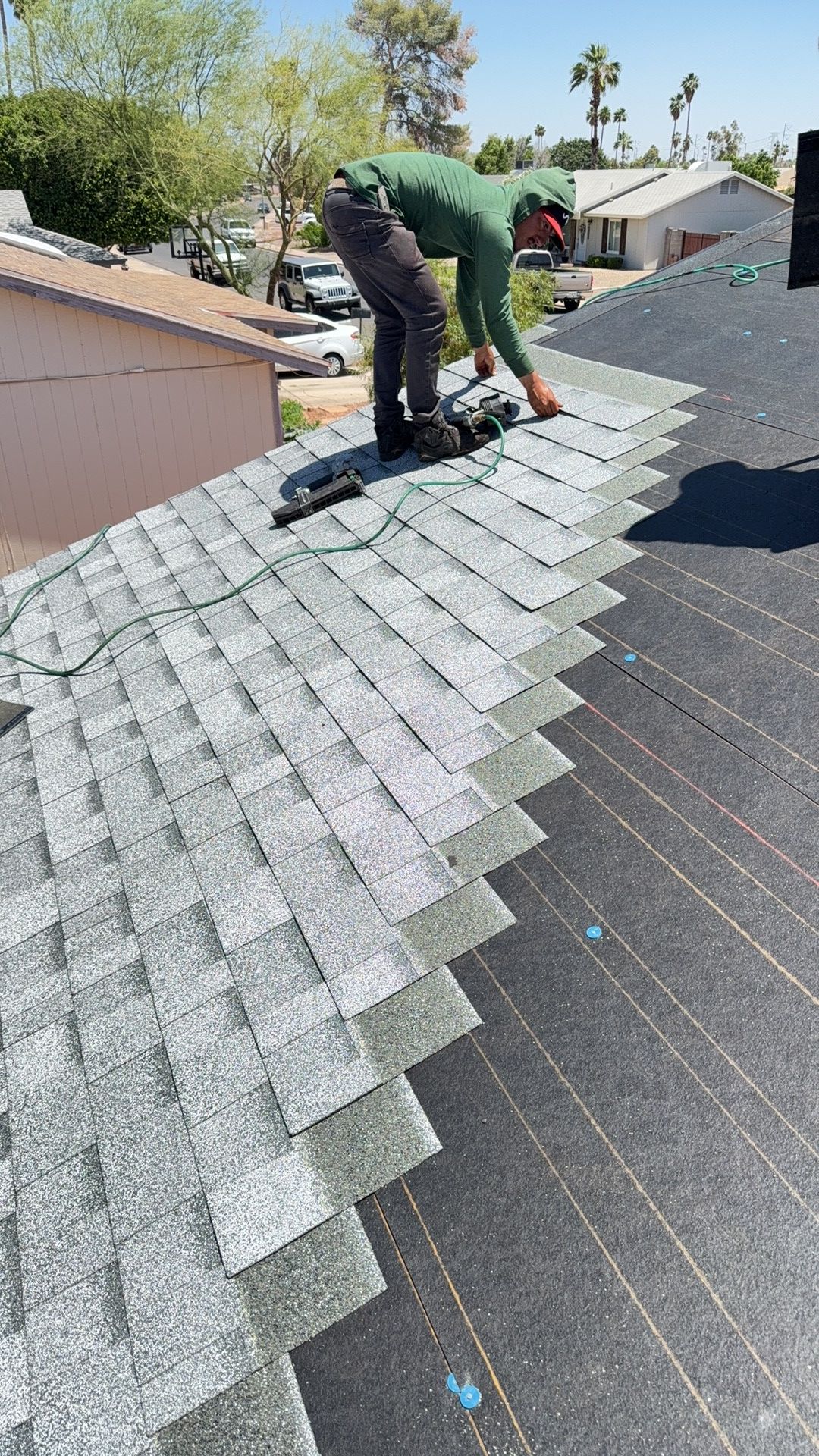 Architectural shingle install · Mesa · 85202 — Wind-lifted shingles across the south-facing field and an active leak above the kitchen.